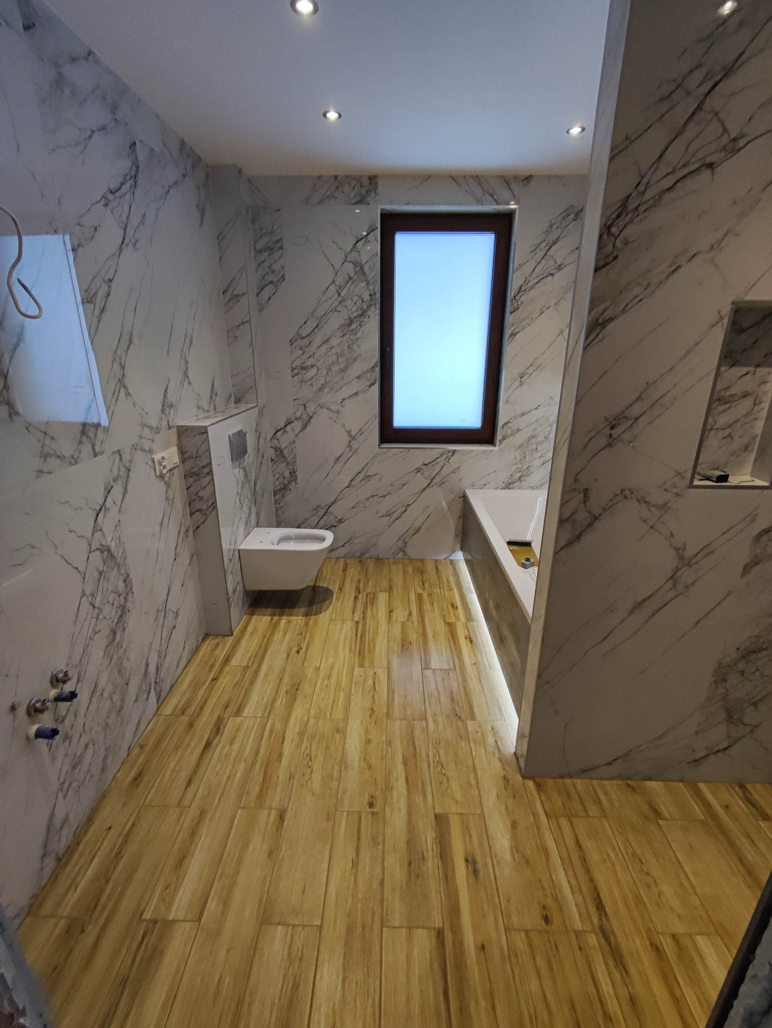 Łazienka w stylu biały marmur oraz panele drewnopodbne